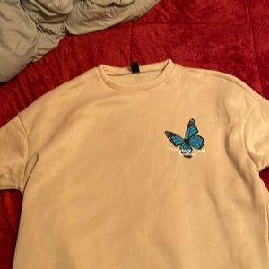 Beige butterfly pullover.